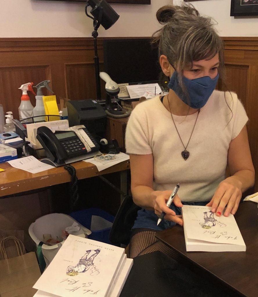 susan sandford blades signs books wearing a mask