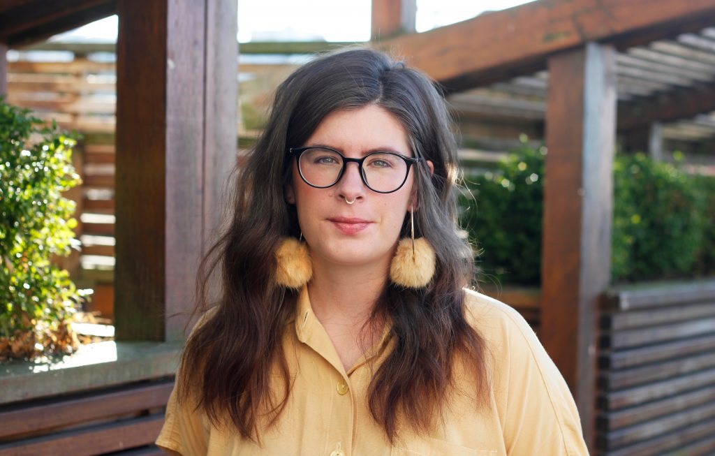 photo of jessica johns in yellow shirt and yellow earings
